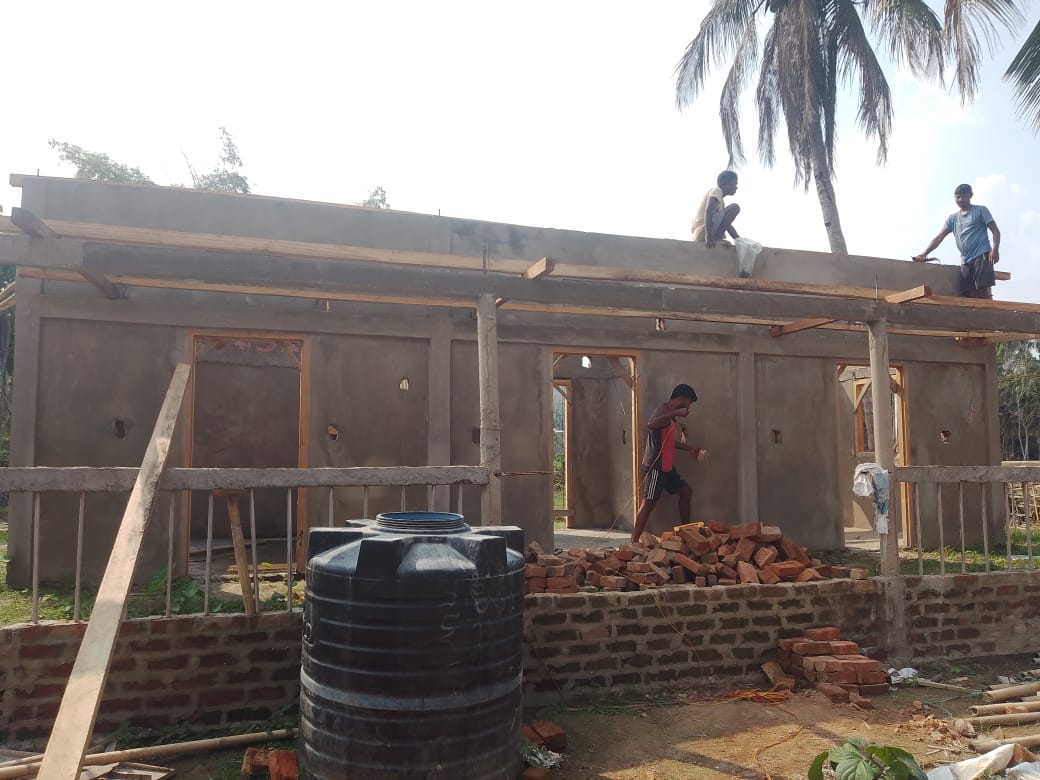 Guest House construction progress workers on roof