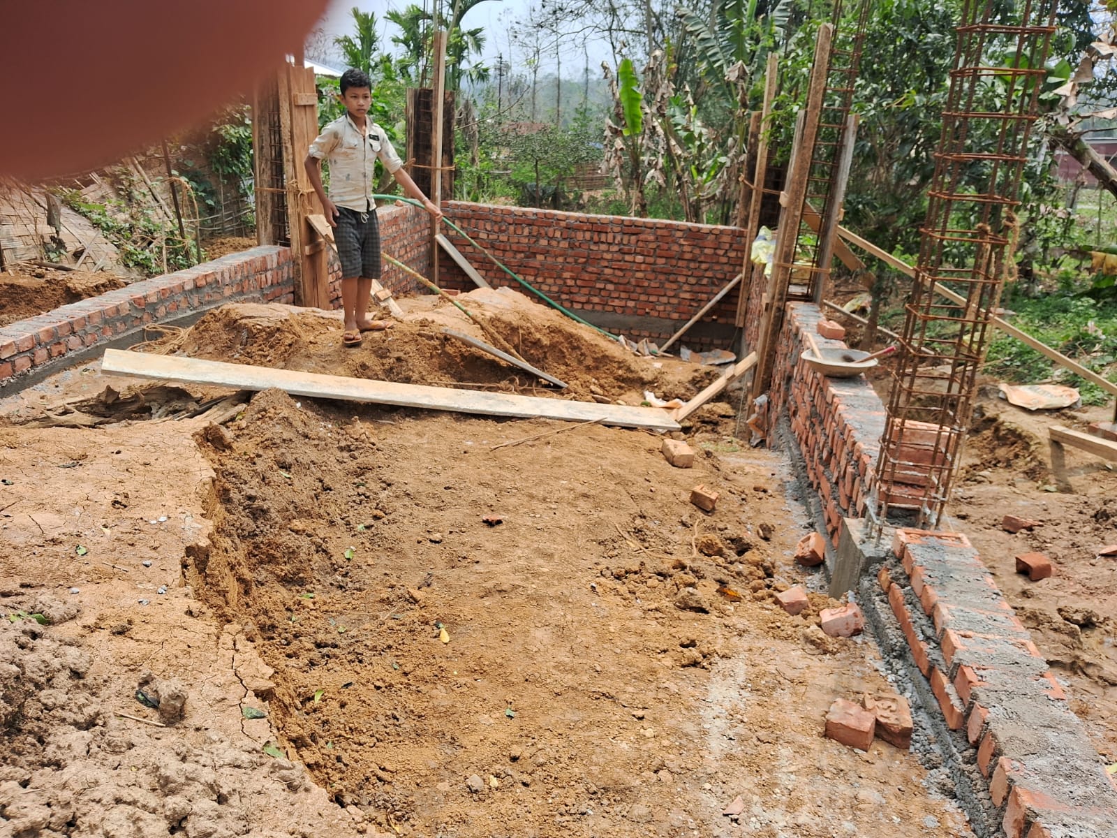Local boy at hostel construction site in Langting