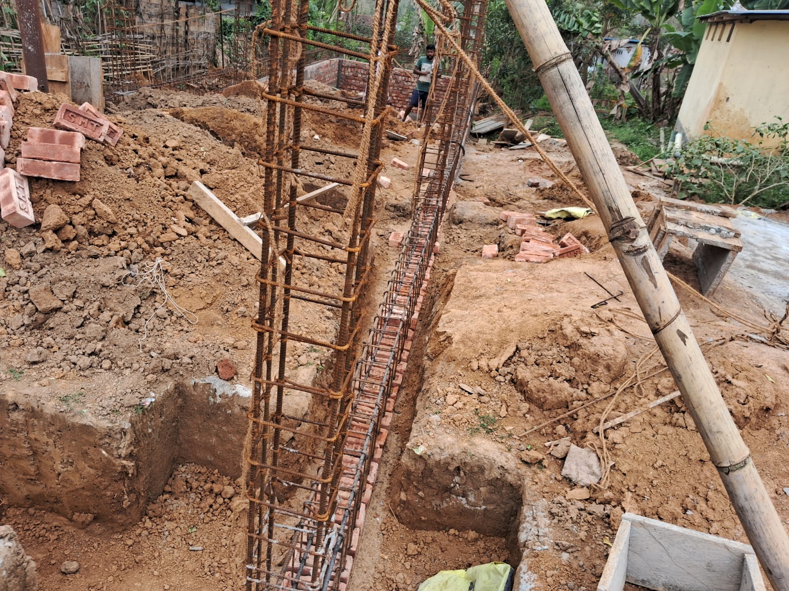 Close-up of rebar columns and excavation at hostel site