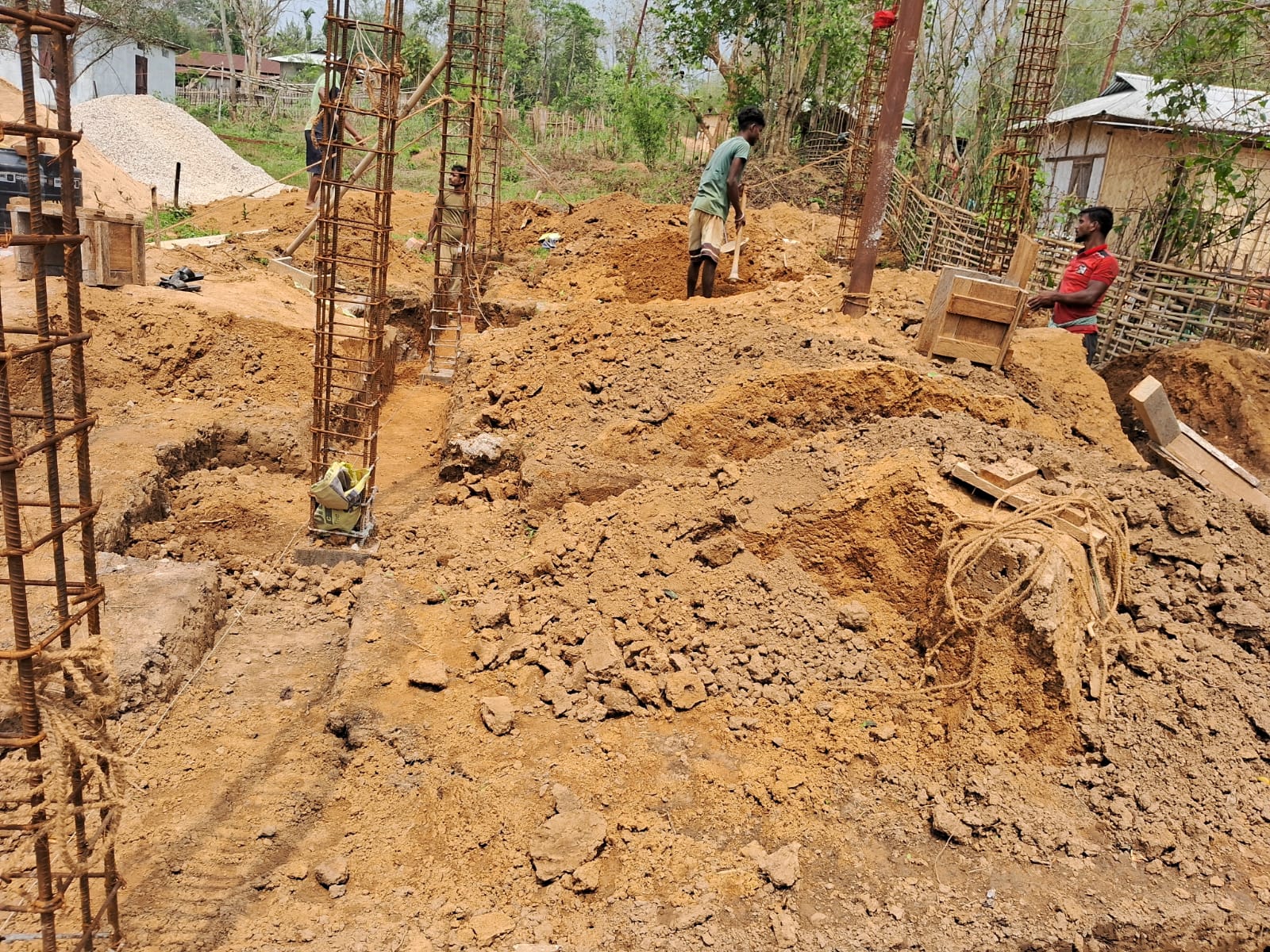 Workers at excavation and rebar column site for hostel