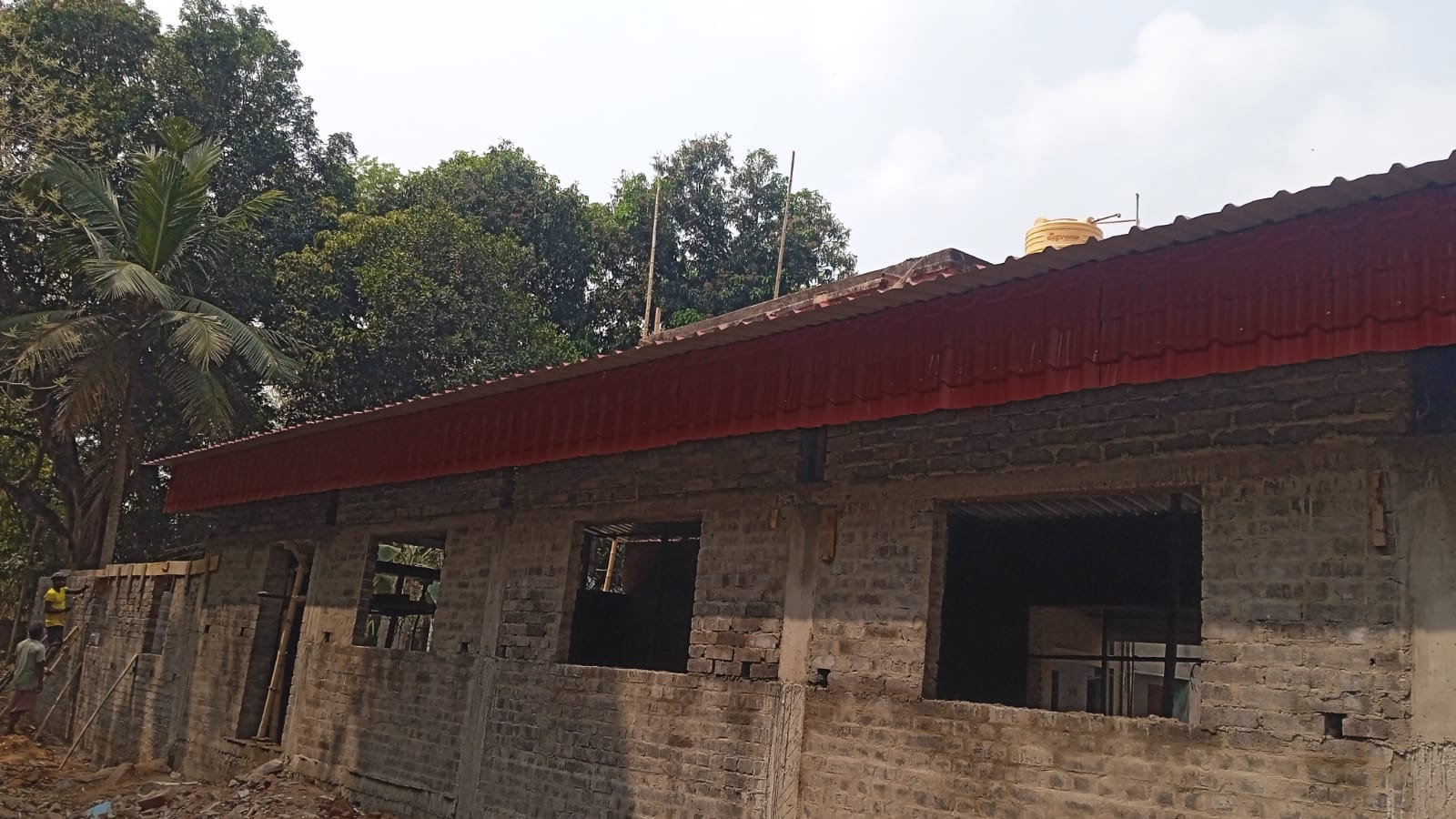 Prayer hall side brick wall with red roof and bamboo