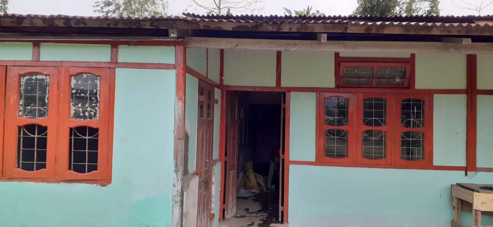 School building renovation at Lumding freshly painted front with red window frames