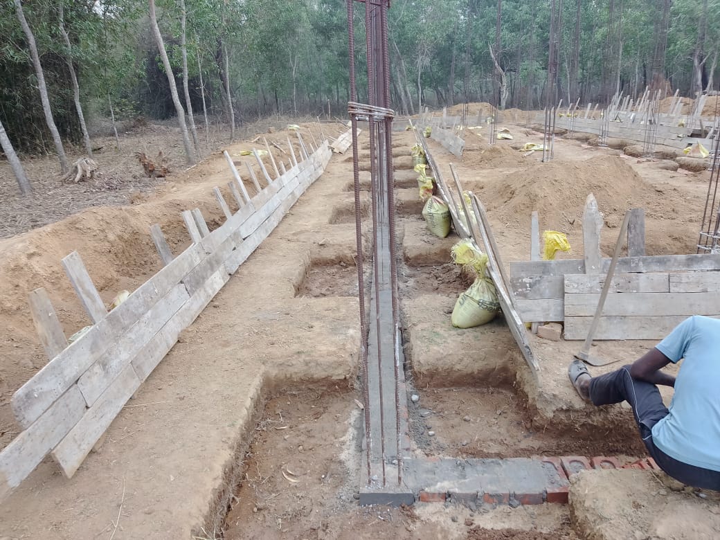 School construction at Mada Pada — rebar columns and formwork close-up