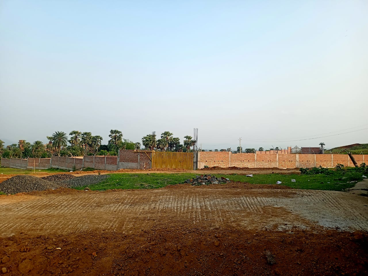 Construction progress at Labri with boundary wall and yellow gate